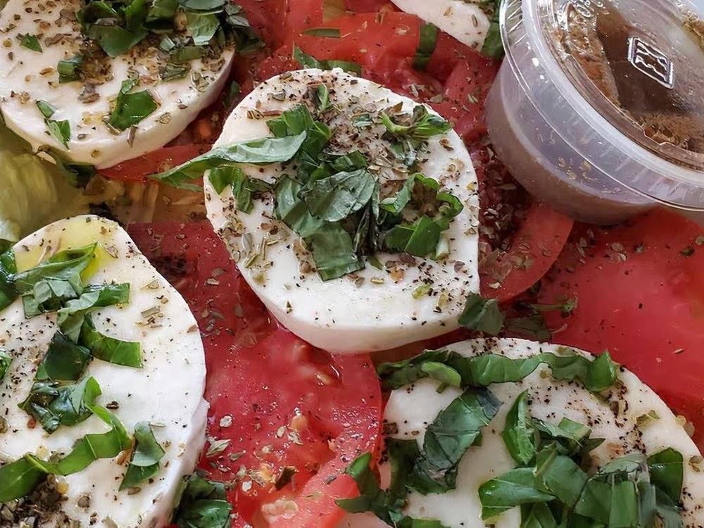 Caprese salad with fresh mozzarella, vine tomato and basil